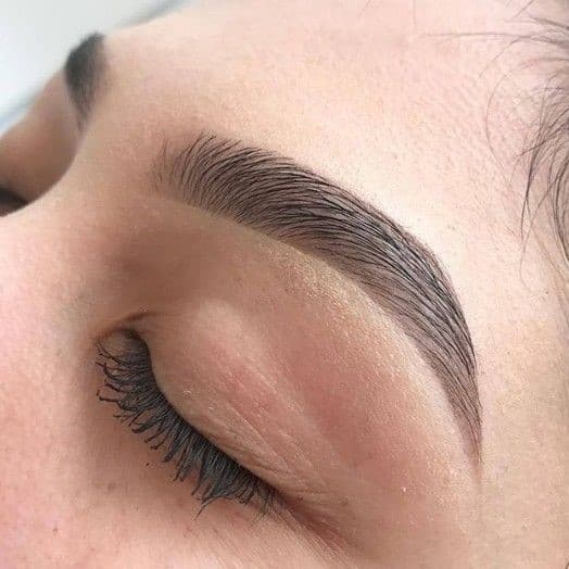Zoom on a dyed, plucked and restructured eyebrow after eyebrow restructuring.